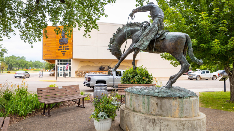 a cowboy and horse statue outside of the North Dakota Cowboy Hall of Fame