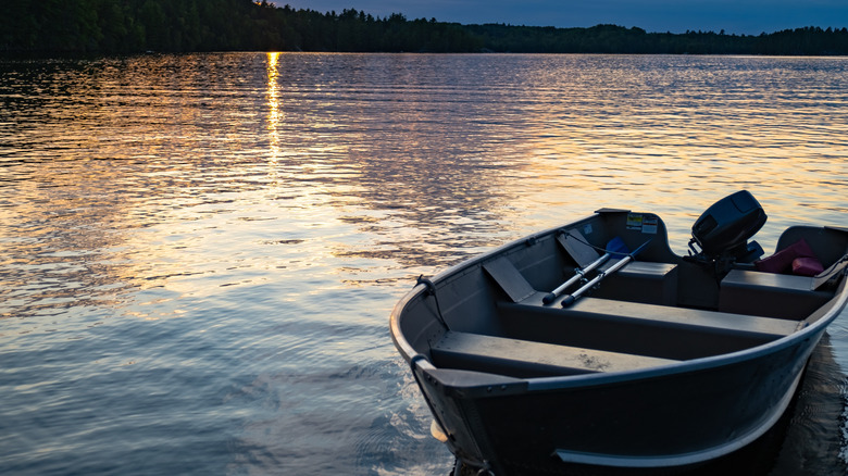 A fishing boat at edge of lake during sunset in Voyageurs National Park