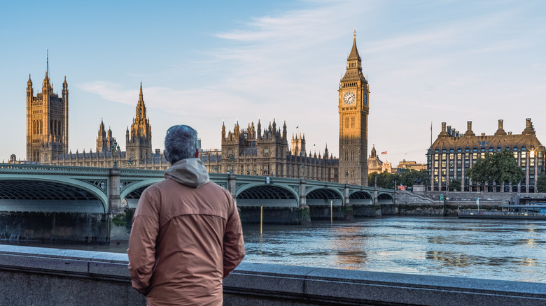 Man looking out at the Big Ben in London