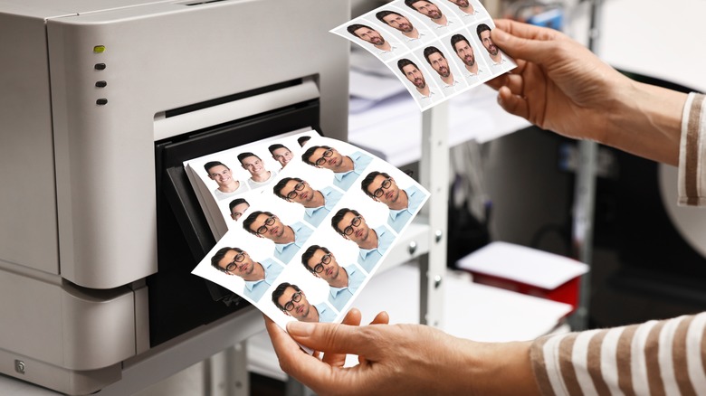 Passport photos coming out of a printer