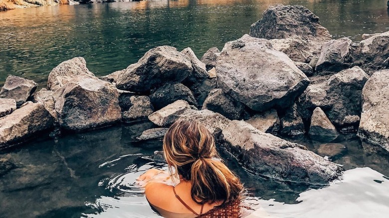 Woman soaking in the Black Rock Hot Springs in New Mexico