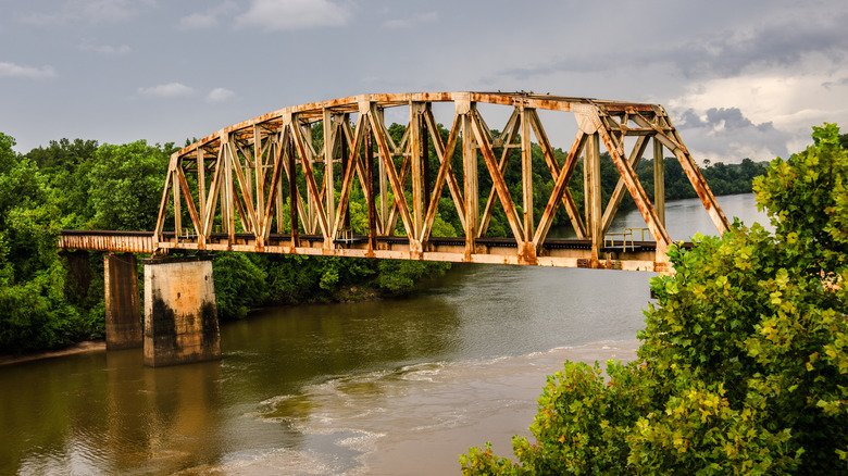 A rusty railroad bridge spans the Chattahoochee River on the border of Georgia and Alabama.