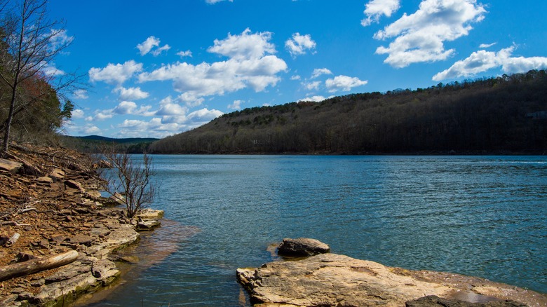 A view of Greers Ferry Lake from a rocky shore, with clear, blue waters and clear skies