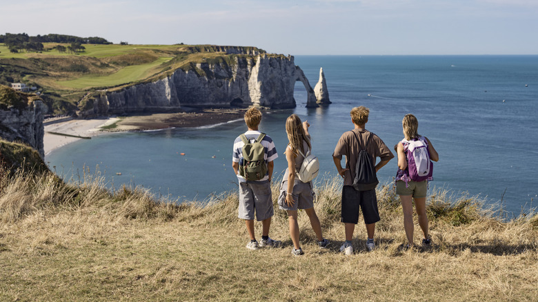 Tourists hiking in Etretat, Normandy