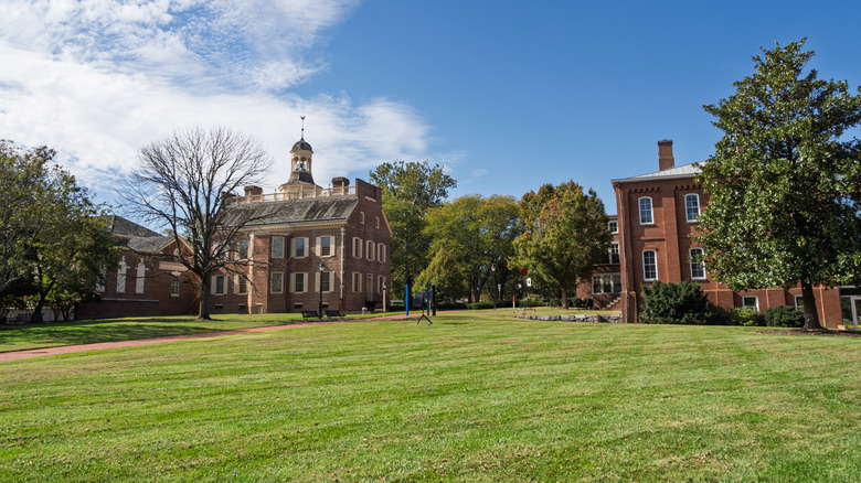 Wide-angle view of The Green with the Old State House and surrounding historic brick buildings on a sunny day in Dover.