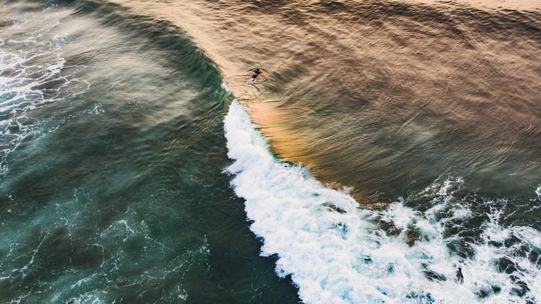 Ocean waves catching the light of a sunset
