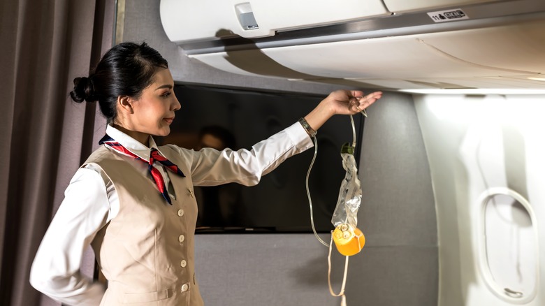 Flight attendant during safety demonstration