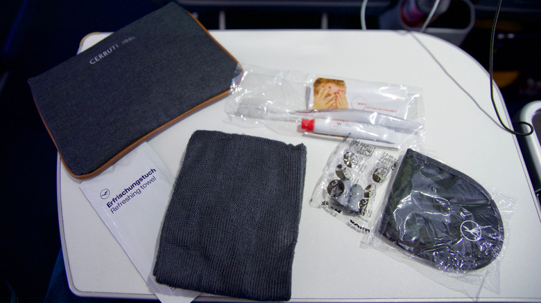 Contents of an in-flight amenity kit spread out on a table