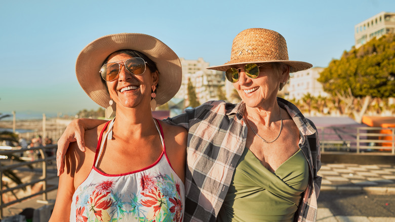 Two older women walking along the beach