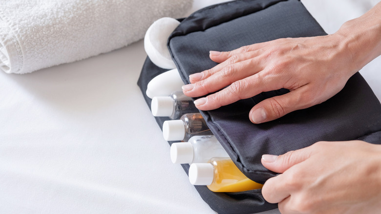 Travel containers being packed in a toiletry kit
