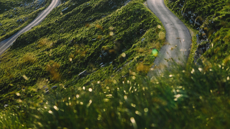Sharp mountain road curve in the Balkan Alps at sunrise