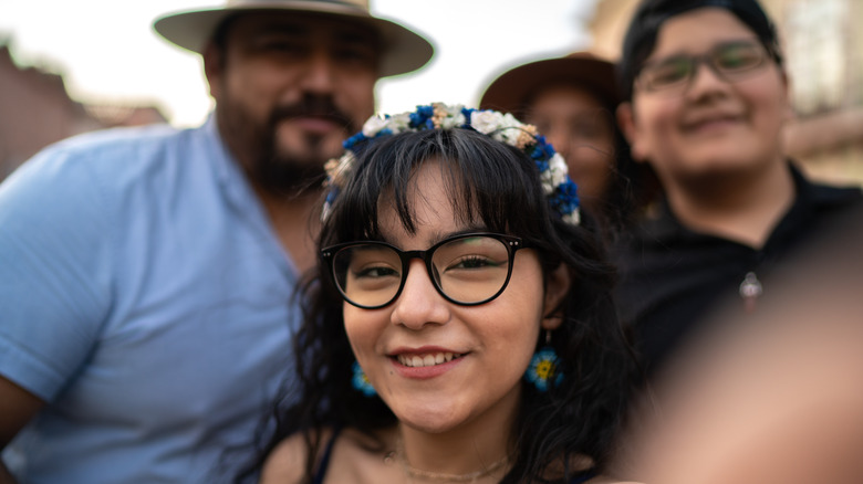 family taking selfie outside