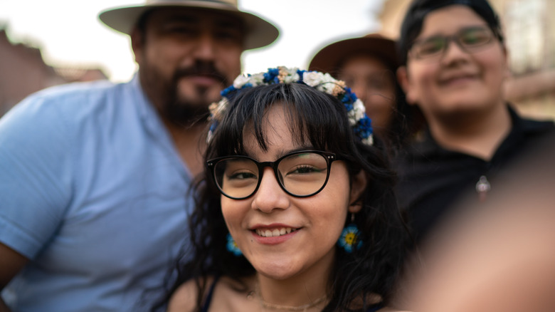 family taking selfie outside