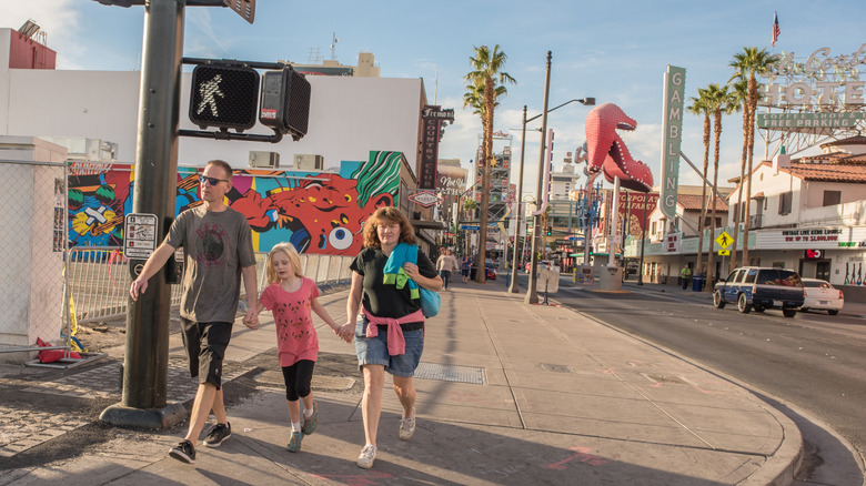 A family walking down East Fremont Street in Downtown Las Vegas