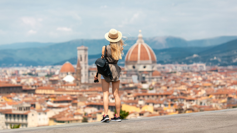 Woman from behind looking out over Florence's skyline on clear day
