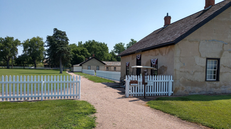 Historic buildings at Fort Hartsuff in Nebraska seen from dirt road