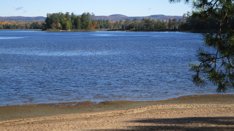 Sandy beach on New York's Middle Saranac Lake in daylight