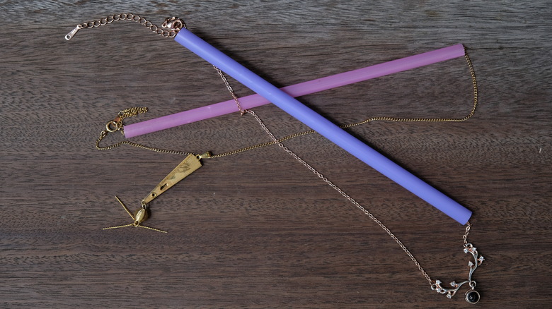 necklaces strung through straws to keep them untangled