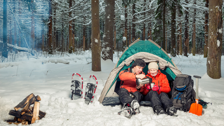 A couple camping in winter