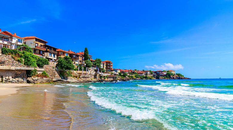 Empty beach on a clear day surrounded by buildings in Sozopol, Bulgaria