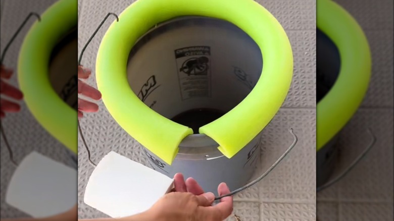 DIY camping toilet with a pool noodle and a bucket