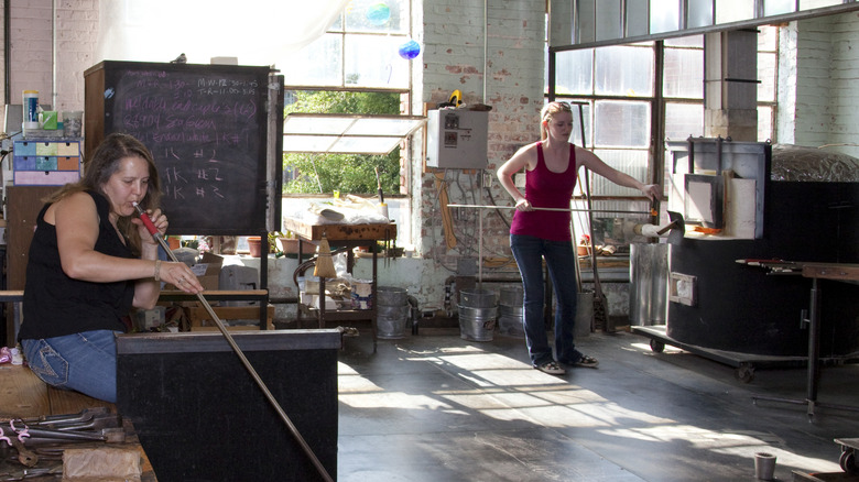 Glass blower Susan Knecht and associate Allison Smith create glass artwork in the Lowe Mill Art Center and Gallery in Huntsville, Alabama