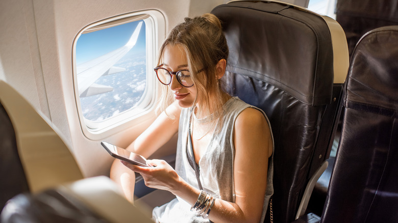 airplane passenger on phone