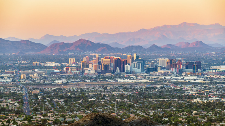 Phoenix skyline at sunset, with red mountains in the background