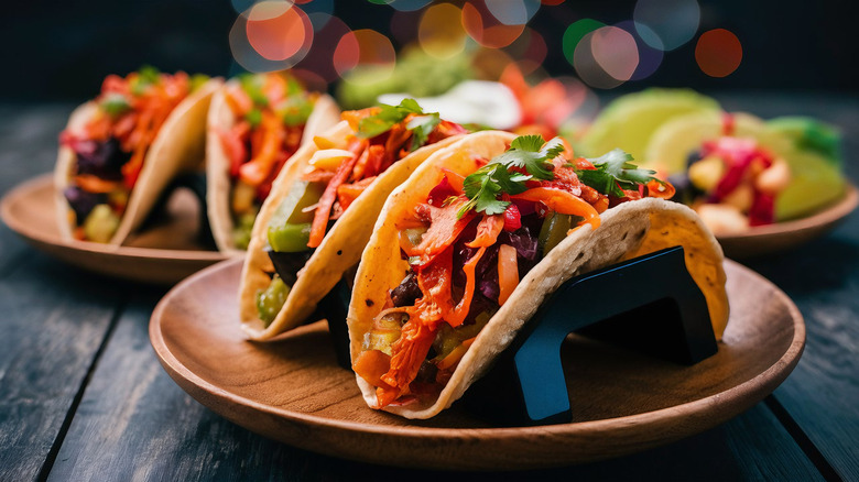 A Phoenix specialty, authentic Mexican tacos are propped up on polished wood plates.