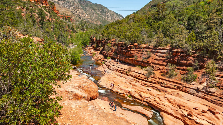 Visitors enjoying the water and canyon views at Slide Rock State Park in Sedona, Arizona