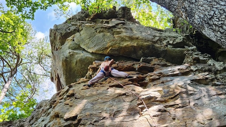 Climber high up on bluff