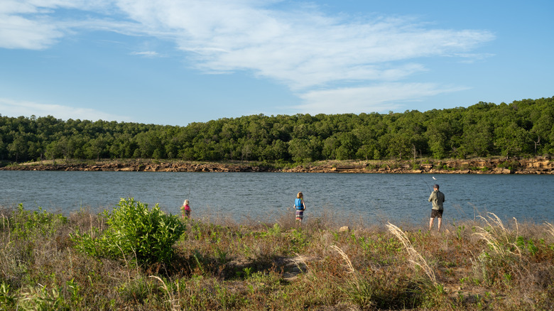 Family fishing from shore at Skiatook Lake