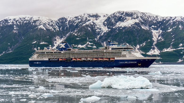 Cruise ship in front of glacier with icy water in Alaska