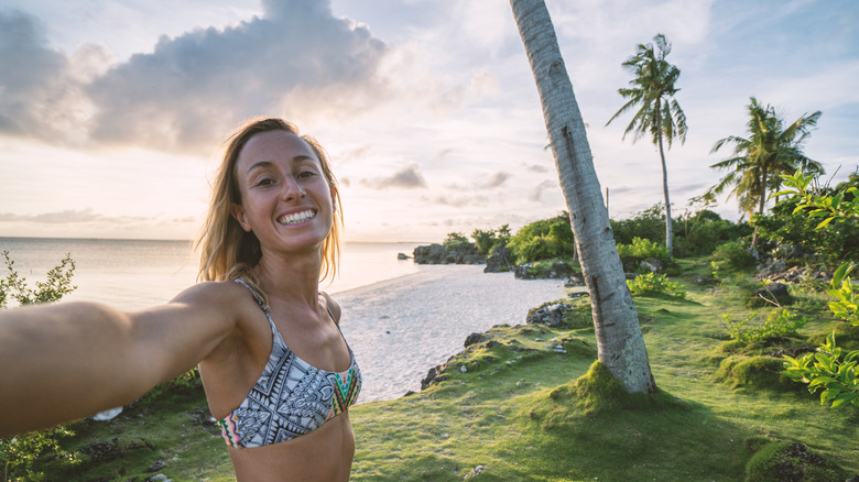 Woman taking a selfie in the tropical landscape of the Visayas Islands in the Philippines