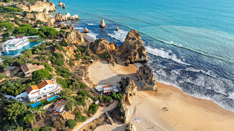 Aerial view of rocks and houses at praia Tres Irmaos near Alvor in Algarve Portugal