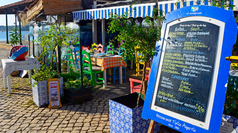 Menu in front of restaurant at seaside near beach, Alvor, Algarve