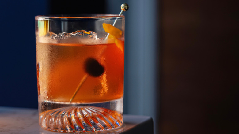 A gin cocktail perched on the edge of a table