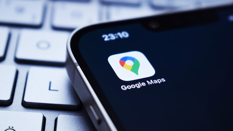Google Maps app icon displayed on a smartphone resting on a keyboard