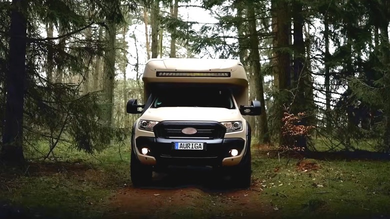 Auriga Explorer camping truck driving off-road through a forest