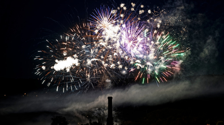 Fireworks erupt in the sky over Le Puy-en-Velay at night