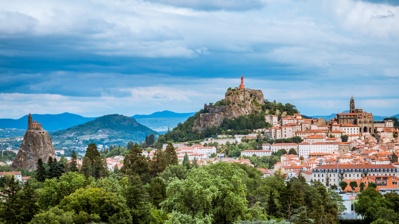 The city of Le Puy-en-Velay, with statues and cathedrals sitting atop volcanic hills
