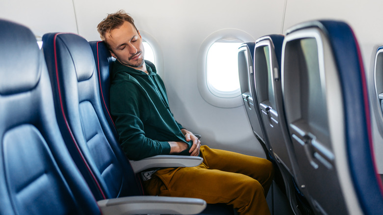 A man sleeping on a plane