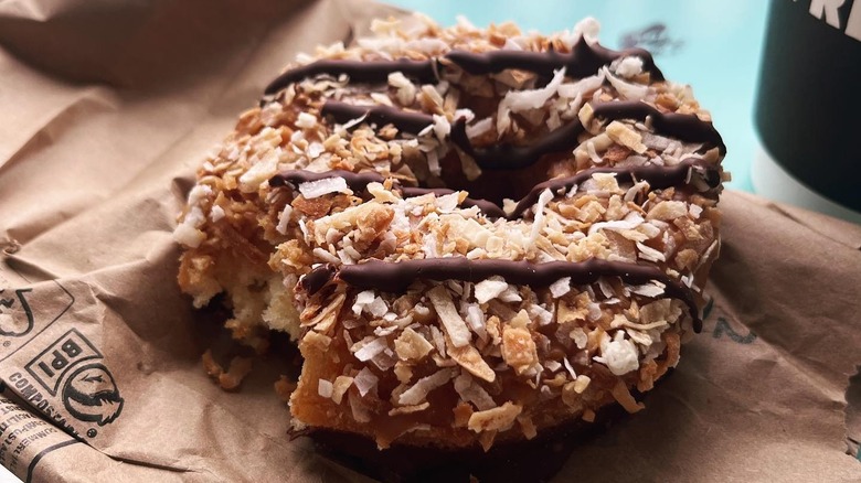 A donut with coconut and chocolate drizzle from Donut Friend