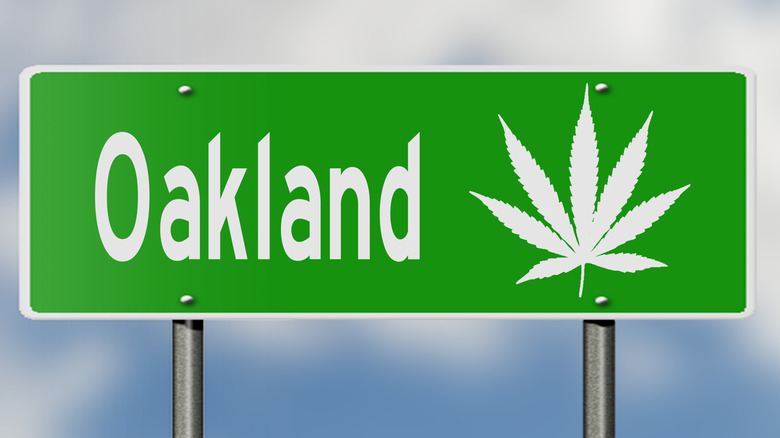 Highway sign for Oakland with marijuana leaf