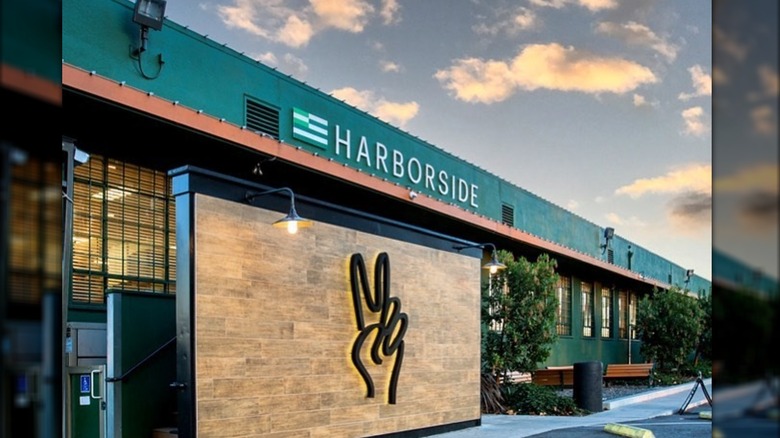 Harborside storefront against cloudy sky