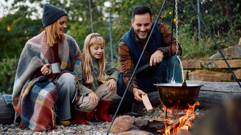 People cooking on a campfire