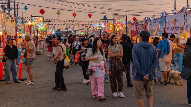 People walking around the Richmond Night Market at dusk