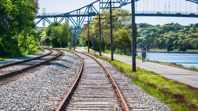 A view of the Cape Cod Rail Trail alongside the Cape Cod Canal and beneath the Sagamore Bridge