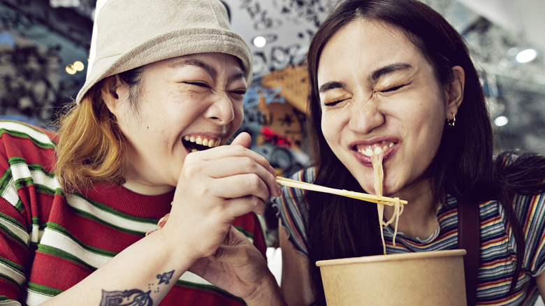 People enjoying noodles in Bangkok