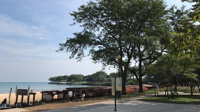 A view of Addams Memorial Park, showing trees, a walking path, and Lake Michigan views